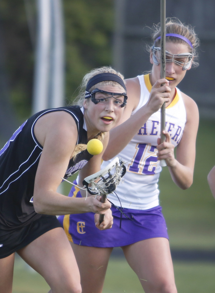 Korinne Bohunsky of Marshwood reaches to control the ball ahead of Brooke McElman at Cheverus. Marshwood improved to 7-2 with its victory and also dropped the Stags to 3-5.