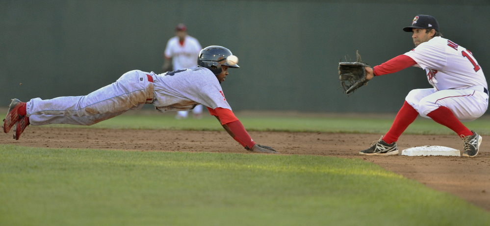 Reading’s Roman Quinn dives back into second base as Portland’s Mike Miller waits for the throw Friday at Hadlock Field.