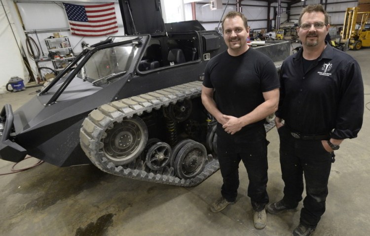 Mike Howe, left, and Geoff Howe show off their Ripsaw EV 2 in Waterboro in 2015. One of their vehicles earned an extended action sequence in “Mad Max: Fury Road.” The company has won a People’s United Bank Innovation & Technology Award. 