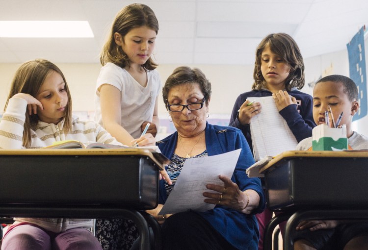 Foster Grandparent Fran Seeley helps third-graders, from left, Alexus Chapman, Charlotte Libby, Lucy Tidd and Donald Enman with math at Lyseth Elementary School in Portland on Tuesday. “Sometimes with math I get a little bit like I don’t believe in myself, but now I feel like I’m getting better,” Charlotte said.