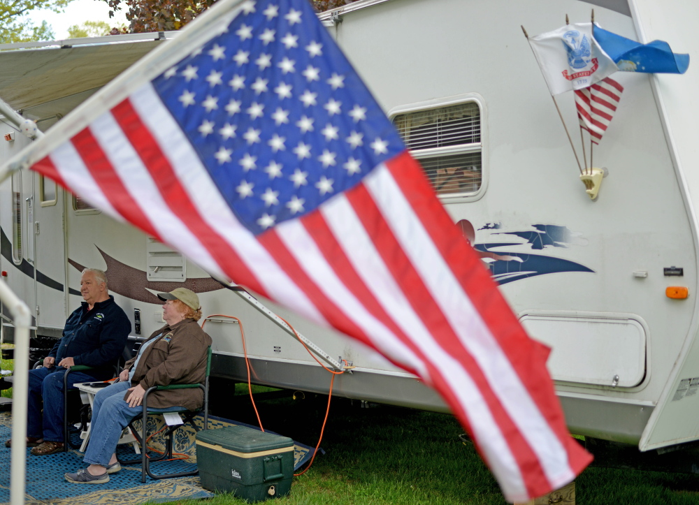 Lenny and Susan Turcotte, of Portland, relax on Friday in front of their camper at Two Rivers Camp Ground in Skowhegan. The couple makes about eight camping trips a year.