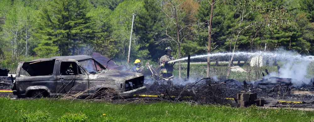 Firefighters work at the scene of a fire that destroyed a chicken barn Saturday in Pittston. Joe Phelan/Kennebec Journal
