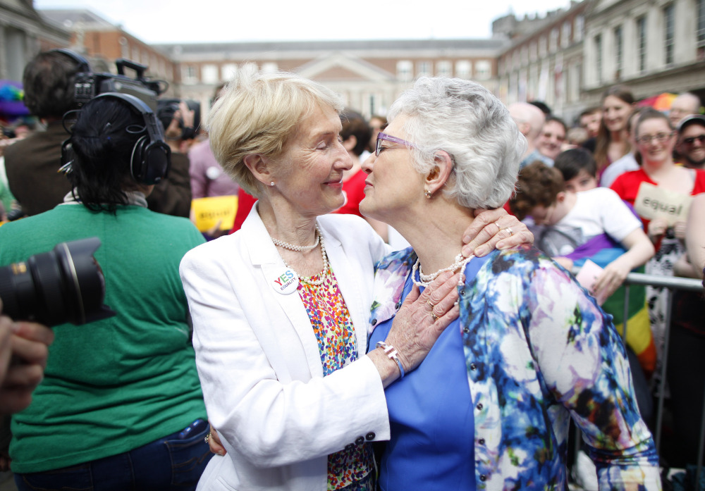 Irish Senator Katherine Zappone, right, and partner Ann Louise Gilligan celebrate as the voting results come in at Dublin Castle.  side’s)