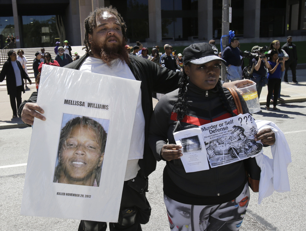 Alfredo Williams, left, and Renee Robinson, cousins of Malissa Williams who was one of the victims, protest outside the courthouse after the Michael Brelo verdict Saturday in Cleveland. Brelo, 31, was acquitted.