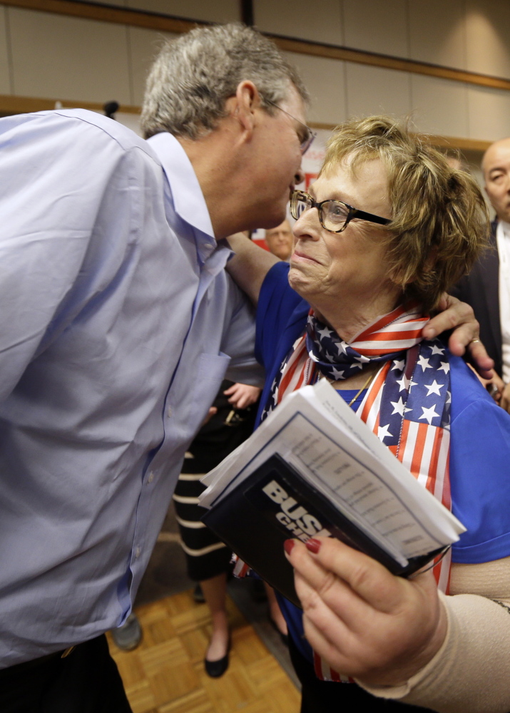 Former Florida Gov. Jeb Bush gets a hug from a supporter after a town hall meeting May 16 in Dubuque, Iowa. Some Iowa Republicans wonder if he could beat Hillary Clinton in 2016.