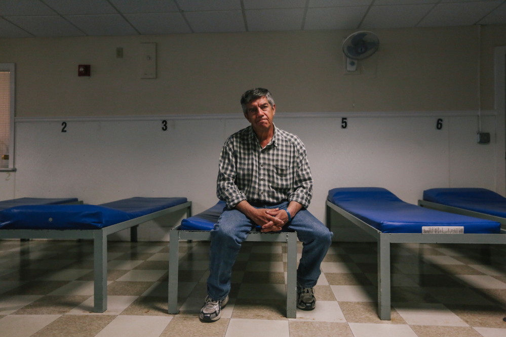 Chris Muse, 58, sits in the male dormitory of Portland’s Oxford Street Shelter. Muse, a former state legislator, lost his home after it was condemned by the city of South Portland because of a broken sewer pipe. He has been homeless ever since. Whitney Hayward/Staff Photographer