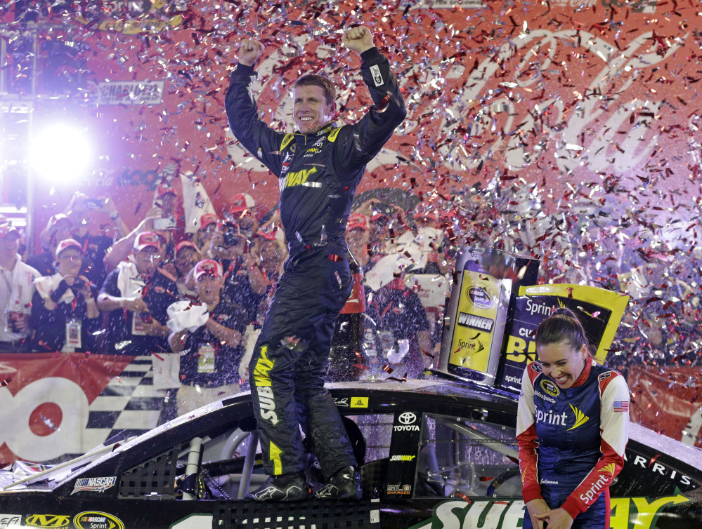 Carl Edwards celebrates Sunday night after winning the Coca-Cola 600 at Charlotte Motor Speedway. The victory was the first for Edwards since he joined Joe Gibbs Racing.