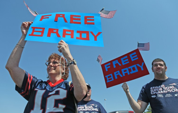 Doreen Domina of Enfield, Conn., and her son, Jacob, take part in a rally Sunday at Gillette Stadium in support of suspended Patriots quarterback Tom Brady.