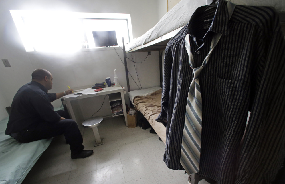 A shirt and tie hang on the bunk of Andres, a 29-year-old serving one year for a deadly drunk driving crash, at the Western Massachusetts Correctional Addictions Center in Ludlow, Mass., last week.