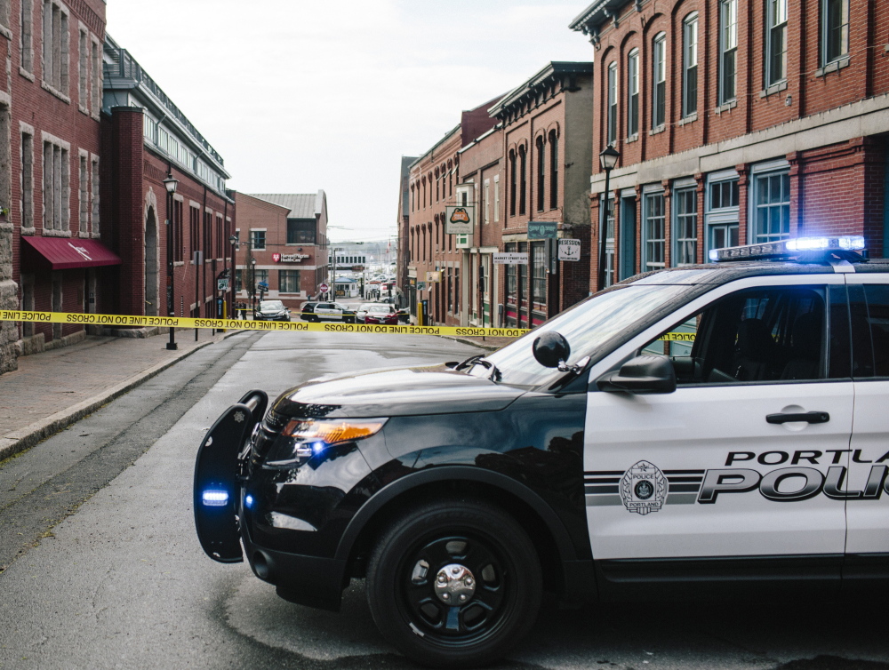 PORTLAND, ME - MAY 26: The section of Market Street between Fore Street and Milk Street is closed off with crime scene tape, following a fatal shooting early Tuesday morning in Portland, ME on Tuesday, May 26, 2015. (Photo by Whitney Hayward/Staff Photographer)