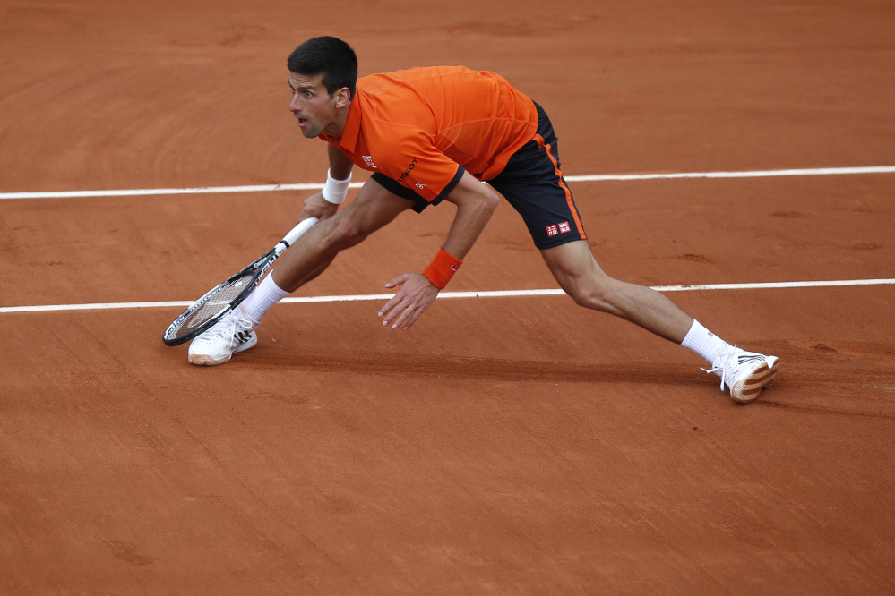 Serbia’s Novak Djokovic eyes the ball after returning in the first round match of the French Open tennis tournament against Finland’s Jarkko Nieminen at the Roland Garros stadium, in Paris, France, Tuesday.