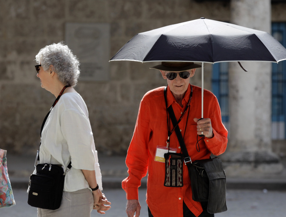Bill Berkson of New York, uses an umbrella as protection from the sun as he tours Old Havana, Cuba, on Sunday. Berkson, whose trip coincided with the Havana Biennial Art Fair, went to Cuba directly from the U.S. with all necessary permissions under a cultural program visit.
The Associated Press