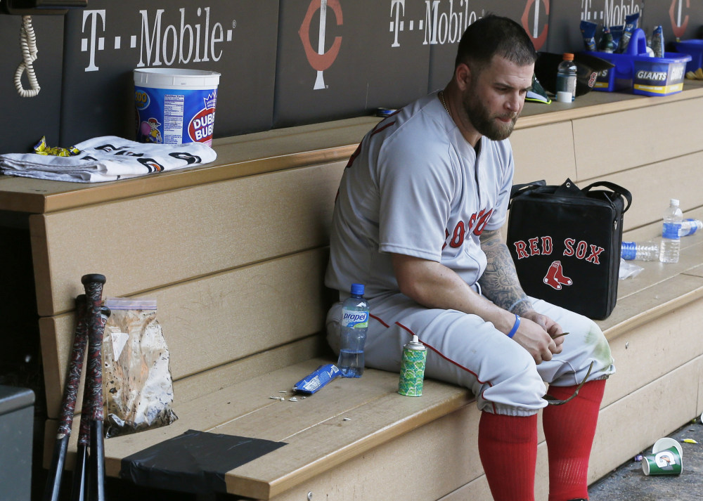 Boston’s Mike Napoli sits alone in the dugout after a May 27 loss to the Minnesota Twins. 