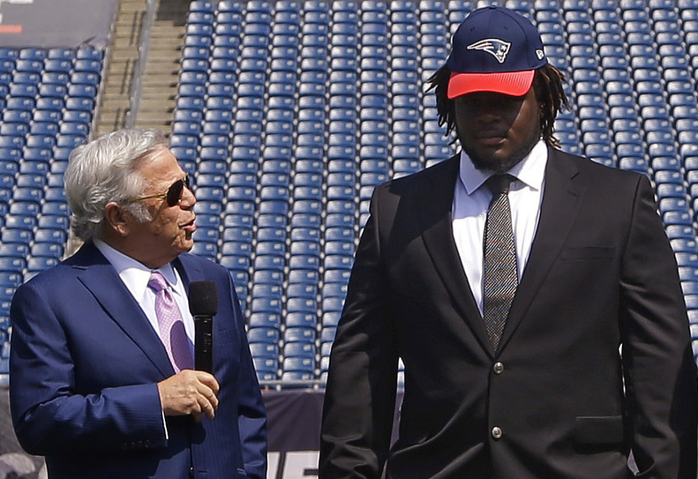 Defensive lineman Malcom Brown, right, said Wednesday that he plans to work hard for his new team, the New England Patriots, and their owner, Robert Kraft, left. About the deflated football scandal? “I’m just here to work.”