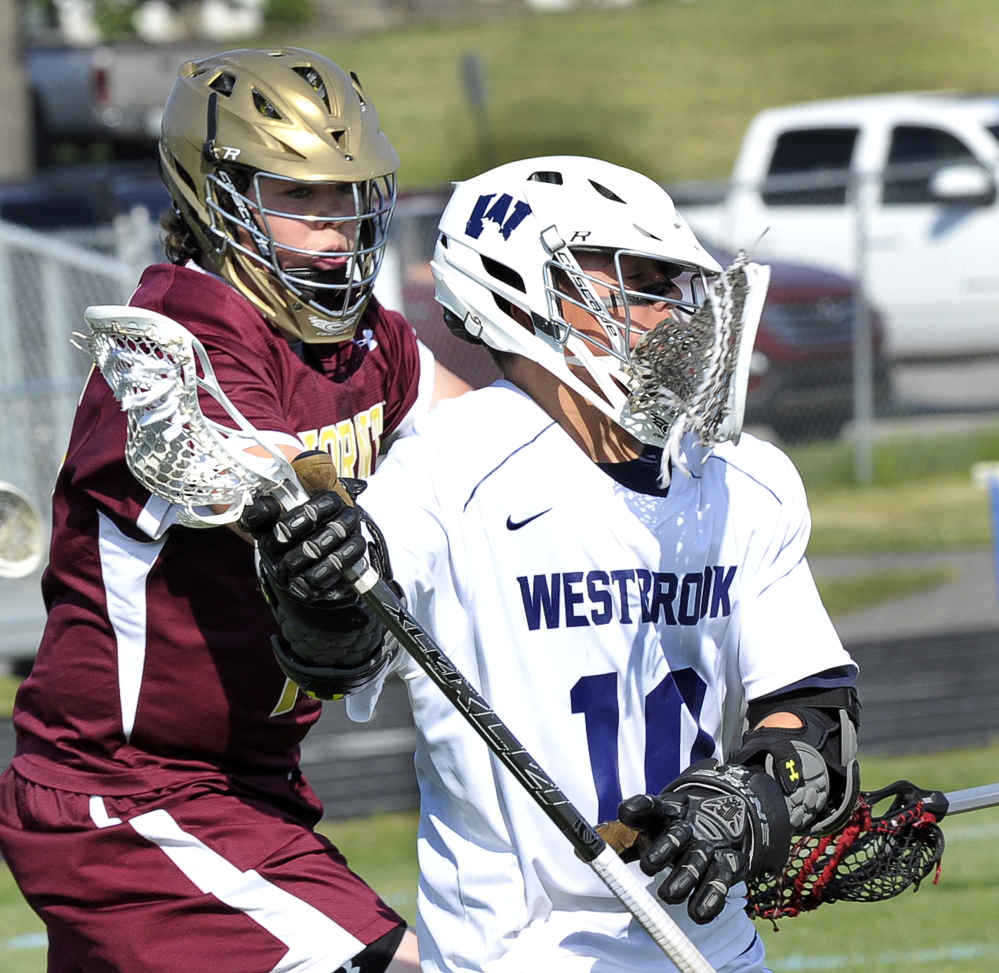 Grayson Post of Westbrook gets part of a stick in the face while attempting to get past Isaac Patry of Thornton Academy, which earned a fourth consecutive victory. Westbrook has lost two straight.