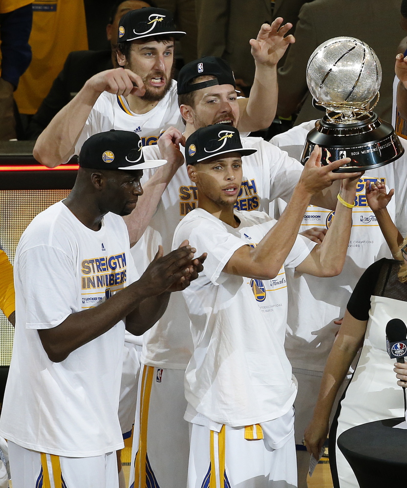 There was plenty of reason for Stephen Curry, holding trophy, and his Golden State teammates to celebrate Wednesday night after clinching a spot in the NBA finals. Game 1 for the Warriors and Cavaliers is Thursday.