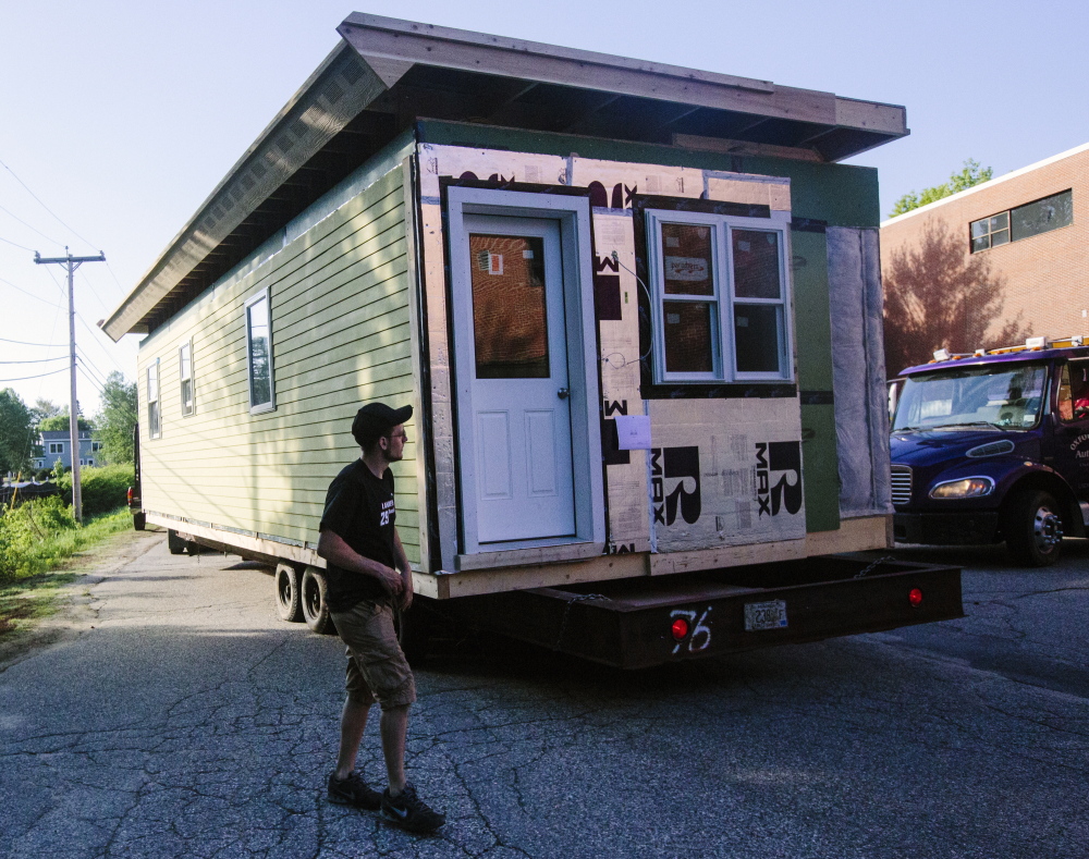 Kyle Hewins from Turn Key Homes walks around the modular home that PATHS carpentry students constructed, as it is loaded onto a trailer to be transported to Durham.