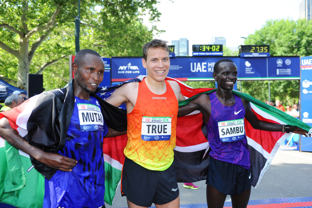 In this photo provided by the New York Road Runners, the first three finishers in the men’s division of the UAE Healthy Kidney 10k pose for a photo in New York City’s Central Park on Saturday. From left are, Kenya's Geoffrey Mutai, third place; American Ben True, first place; and Kenya's Stephen Sambu, second place. 