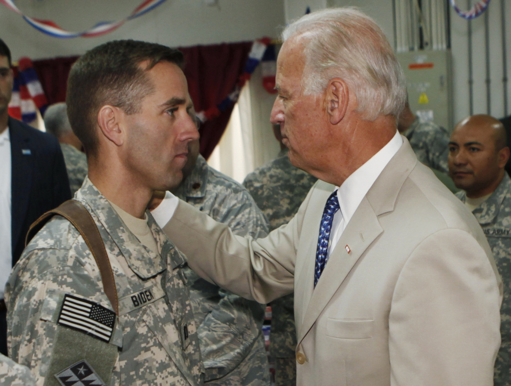 Vice President Joe Biden, right, talks with his son, U.S. Army Capt. Beau Biden, at Camp Victory on the outskirts of Baghdad, Iraq, in 2009.