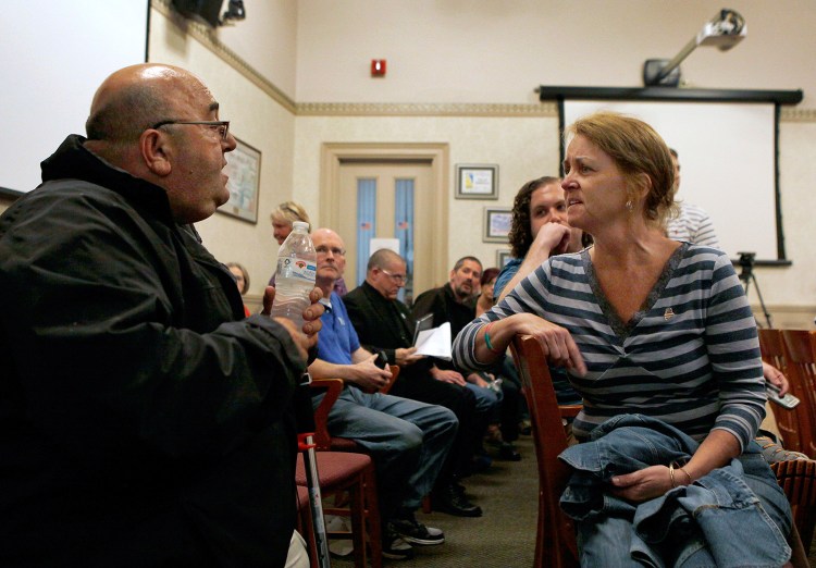 Debbie Lauzon confronts Michael McKeown, a registered sex offender, during the Biddeford City Council meeting Tuesday night. "Why did you molest my son?" she asked McKeown several times before being led from the room by her son.
Joel Page/Staff Photographer