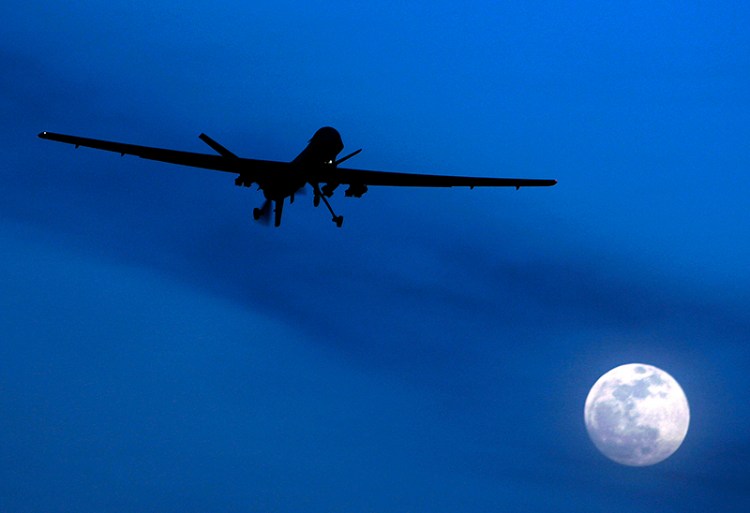 An unmanned U.S. Predator drone flies over Kandahar Air Field, southern Afghanistan, on a moon-lit night.