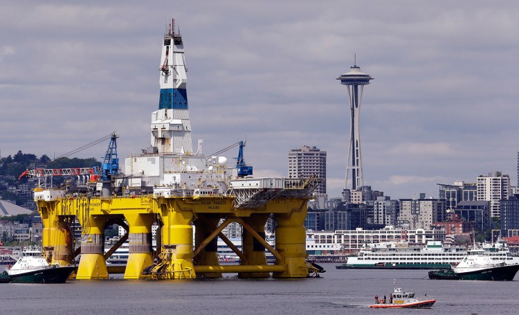 The oil drilling rig Polar Pioneer is towed toward a dock May 14 in Elliott Bay in Seattle. The rig is the first of two drilling rigs Royal Dutch Shell is outfitting for oil exploration and was towed to the Port of Seattle site despite the city's warning that it lacks permits and threats by kayaking environmentalists to paddle out in protest. The Associated Press
