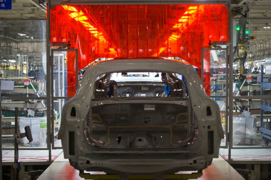 A worker examines the metal frame of a car at a Volvo assembly line in Chengdu in southwestern China's Sichuan province. In addition to building a plant in South Carolina, the company is on the verge of exporting the first “Made in China” cars to the United States. The Associated Press