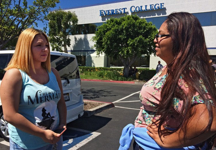 Adriana Garay, 29, right, consults her niece, Haley Sandoval, 17, a student at the now-closed Everest College, in Industry, Calif. The Associated PRess