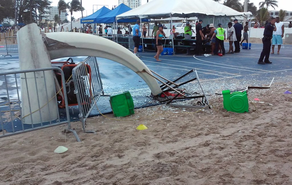 Glass is scattered around a toppled basketball hoop after a waterspout made landfall at a Fort Lauderdale beach. Authorities say three children were injured when the waterspout uprooted a bounce house and sent it across a parking lot into the road. 
Burt Osteen via AP
