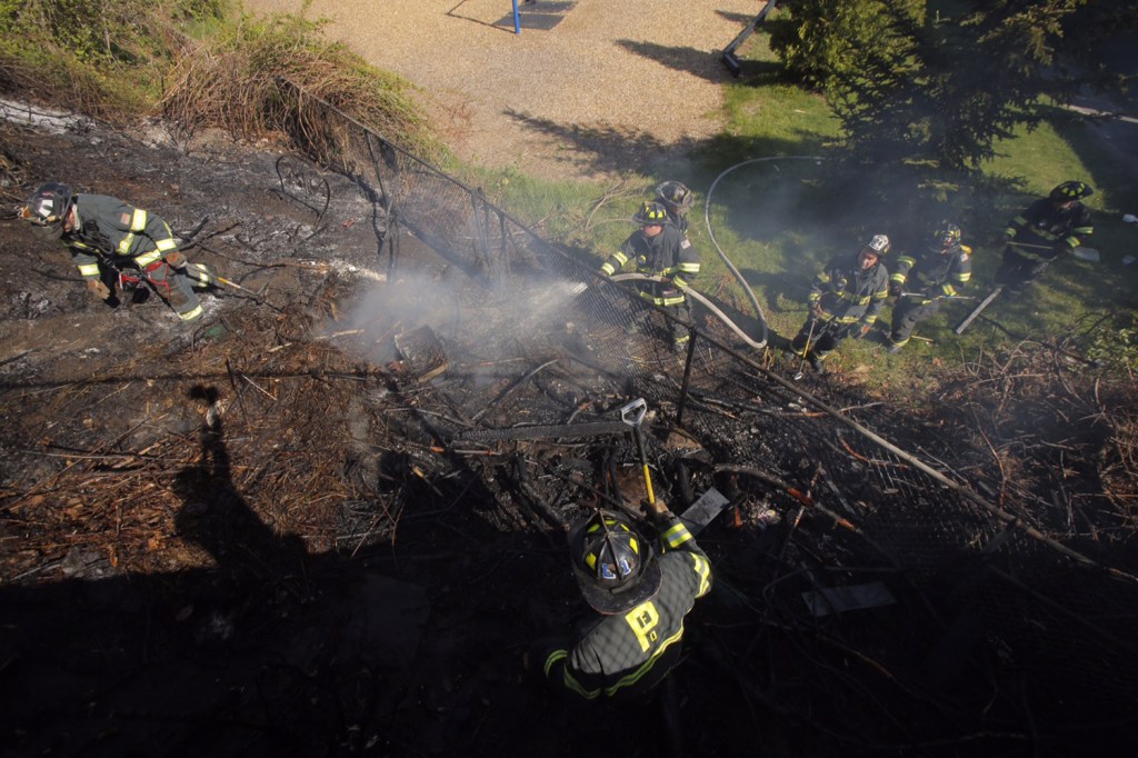 Firefighters extinguish a fire on Munjoy Hill on Thursday.