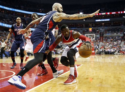 Washington Wizards guard John Wall drives against Atlanta Hawks forward Pero Antic on Friday their NBA playoff games in Washington. The Hawks won and advance to the conference finals against Cleveland. The Associated Press