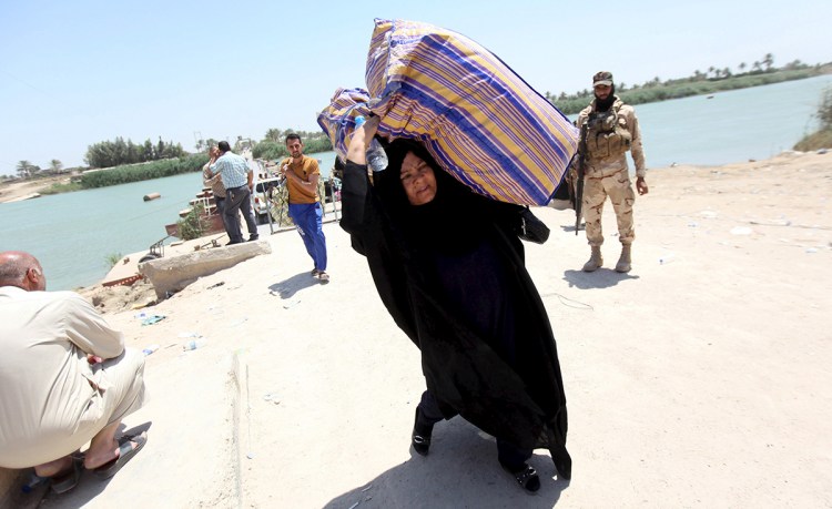 Displaced Sunnis fleeing the violence in the city of Ramadi arrive at the outskirts of Baghdad Saturday. Islamic State militants raised their black flag over the local government headquarters in Ramadi on Friday and claimed victory through mosque loudspeakers after overrunning most of the western provincial capital. Reuters