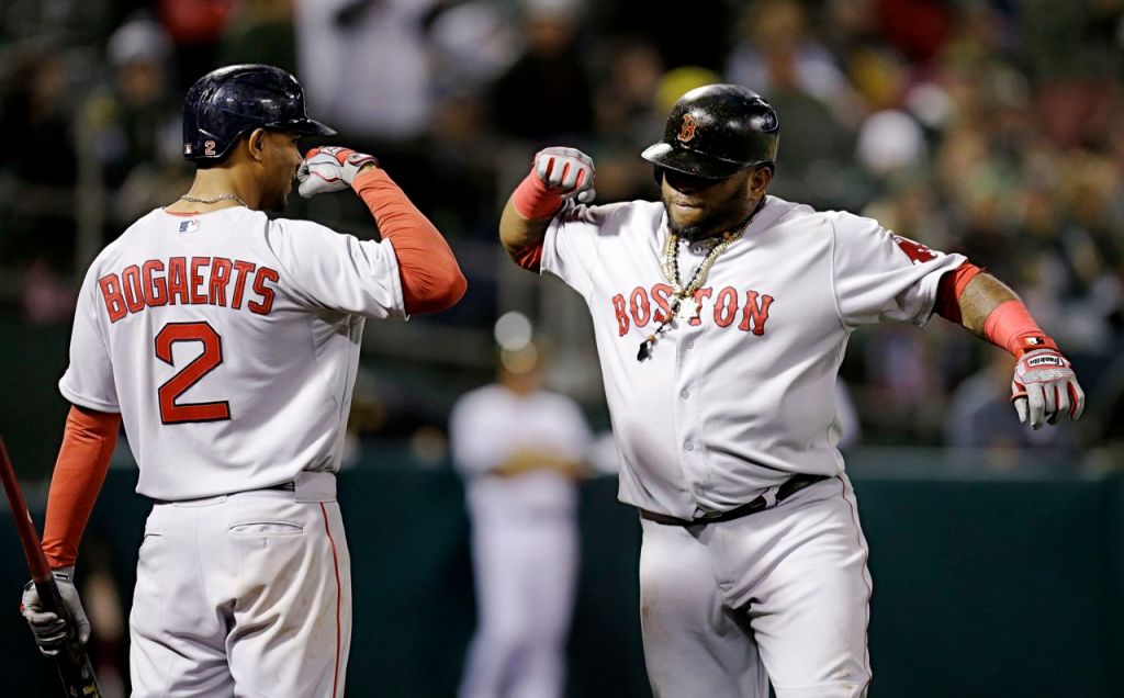 Pablo Sandoval, right, celebrates with Xander Bogaerts (2) after Sandoval hit the game-winning home run in the 11th inning Monday night. The Associated Press