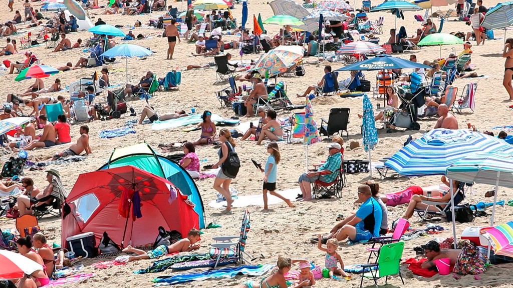 Visitors crowd the sand at Old Orchard Beach in this 2014 Press Herald file photo. The type of summer weather pattern that makes it hotter than normal in the eastern U.S. used to happen about 18 days a summer in the early 1980s. It now occurs about 26 days a summer, the study found.