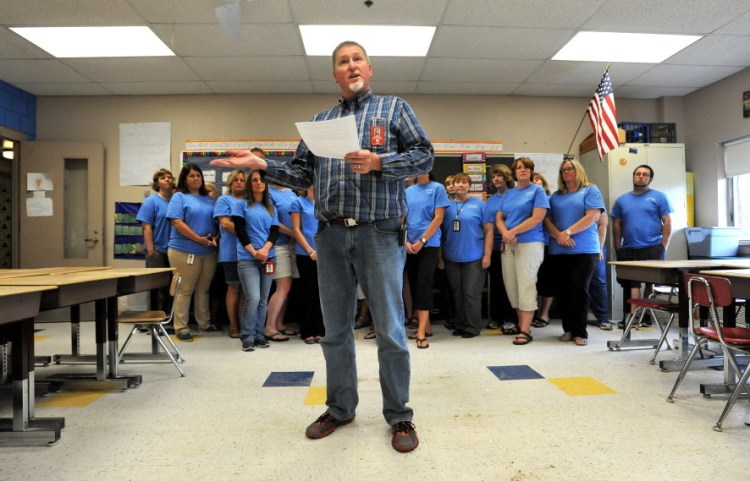 Jeff DeJongh, president of the Augusta Education Association, reads a statement during a news conference Tuesday at Farrington Elementary School in Augusta to address allegations that teachers at the school left posters on a wall that offered assistance to students during standardized testing.