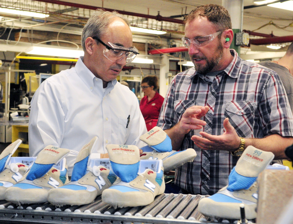 U.S. Rep. Bruce Poliquin, left, and plant manager Chuck Campbell discuss shoes April 10 during a tour of the New Balance factory in Norridgewock. New Balance officials say they have reservations, but are cautiously optimistic after the Senate passed fast track legislation Wednesday that will give the president more authority over trade deals.