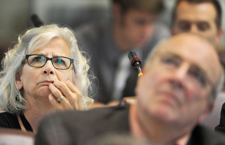 Rep. Joyce McCreight watches the tally board during Monday's House vote on the bill to make concealed-weapons permits optional.