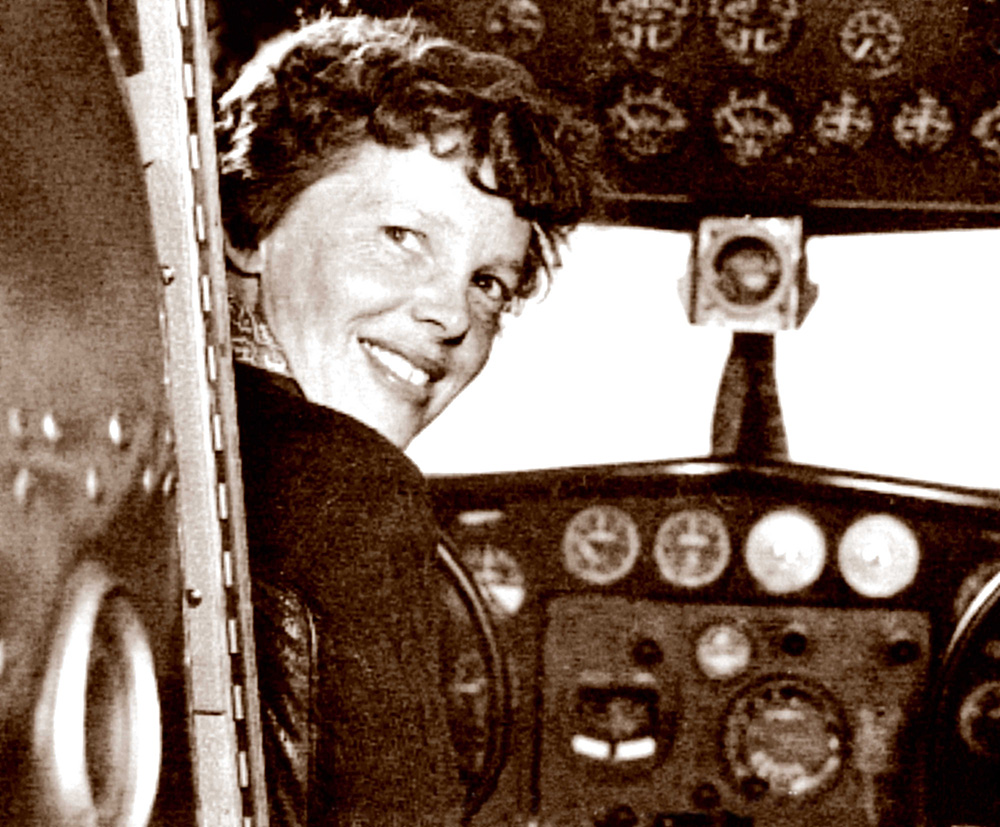 Amelia Earhart poses in the cabin of her Electra plane in this In this May 20, 1937, photo taken by Albert Bresnik at Burbank Airport in Southern California. The Paragon Agency via AP)