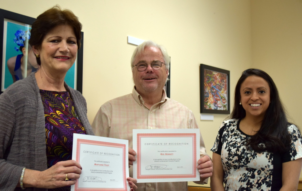 Helena Ackerson, right, chair of the school committee for the Wells-Ogunquit Community School District, presents certificates to the district’s community resource coordinator Maryanne Foley and public information officer Reg Bennett for their leadership in the annual Literary Achievement Awards.