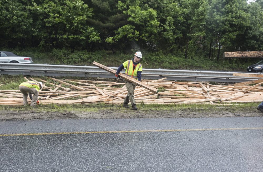 PORTLAND, ME - JUNE 1: Crews clean up lumber in the median between the north and southbound lanes of 295 after a truck spilled its contents in Portland, ME  on Monday, June 1, 2015. (Photo by Whitney Hayward/Staff Photographer)