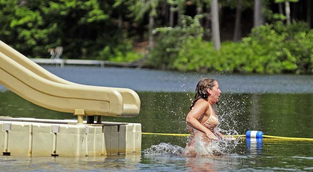 Kristin Lamontagne hits the water of Three Cornered Pond after coming off the slide at Bicentennial Nature Park in Augusta. The city park is open to Augusta residents and their invited guests who must be in the company of an Augusta resident. The park on Route 3 is open every day from 11 a.m. to 7 p.m. through Labor Day weekend.