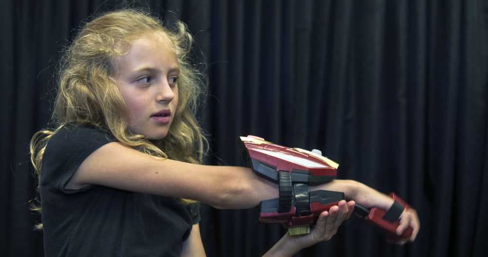 Evangeline Lindes demonstrates a “repulsor,” a wearable forearm attachment with infrared and other sensors that puts kids in the role of Marvel superhero Iron Man as part of Disney’s new line of toys.