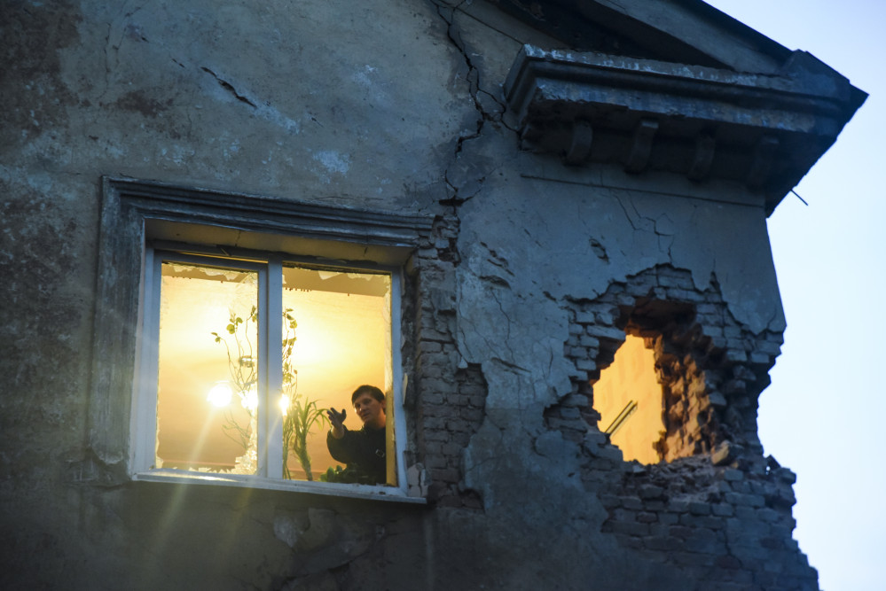 Residents observe damage in their flat after shelling between Russia-backed separatists and Ukrainian government troops in Donetsk, Eastern Ukraine, Monday.