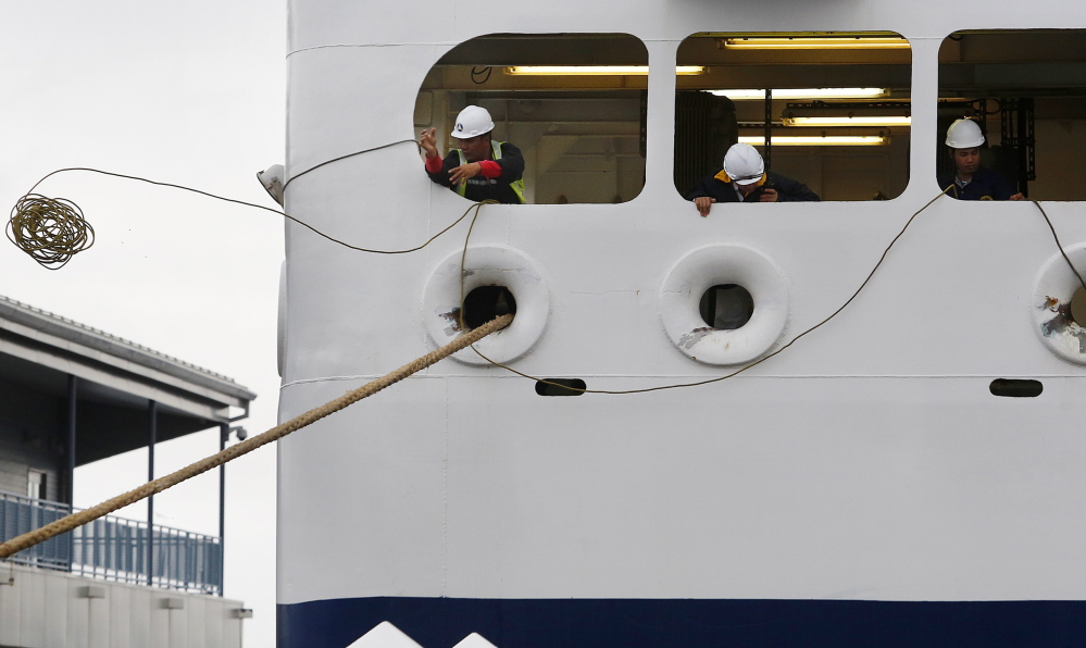 Crewmen work to secure the Nova Star as it arrives in Portland from Yarmouth, Nova Scotia, on Tuesday. The ship gets its provisions almost exclusively from Canadian vendors this year, a flip-flop from its inaugural season last year, when Portland was effectively its home port.