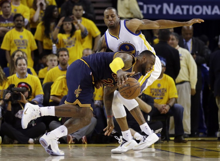 LeBron James drives against Golden State Warriors forward Andre Iguodala during overtime Thursday night. The Cavaliers scored just two points in the overtime and dropped Game 1.