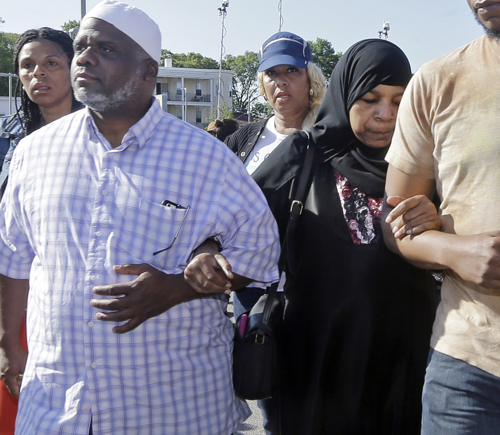 Rahimah Rahim, middle, and Ibrahim Rahim, left, the mother and brother of Usaama Rahim, walk away after a news conference Thursday in Boston’s Roslindale neighborhood where Usaama Rahim was shot to death by police.
