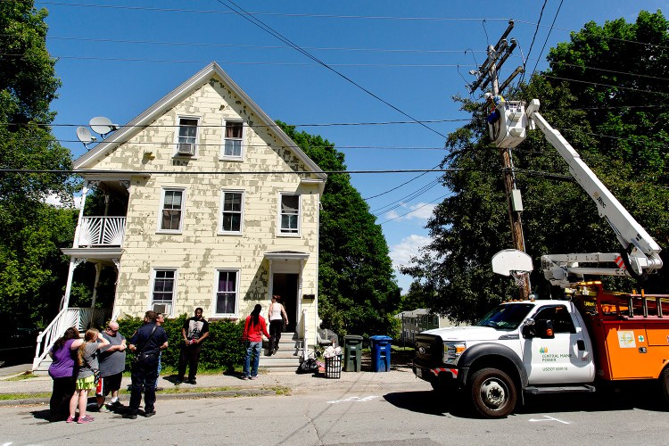 Central Maine Power Co. cuts electricity to the building at 158-160 Brackett St. in Westbrook on Friday after code enforcement officials deemed the building unfit to live in.
Gabe Souza/Staff Photographer