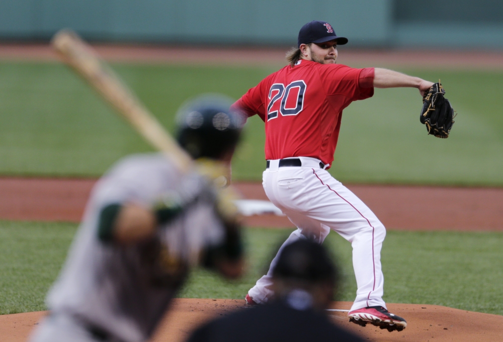 Red Sox starting pitcher Wade Miley delivers in the first inning Friday night against the Oakland Athletics. Miley picked up his fifth win of the season, pitching into the eighth inning.