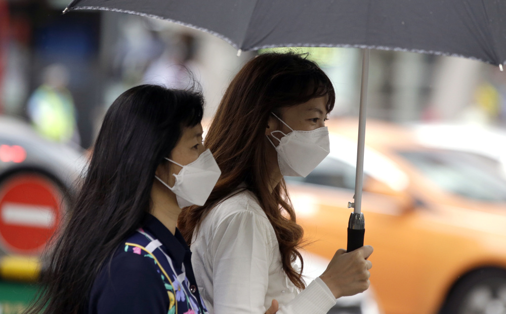 Tourists wear masks as a precaution against Middle East respiratory syndrome Friday in Seoul, South Korea. Four people have died from the outbreak in the nation so far.