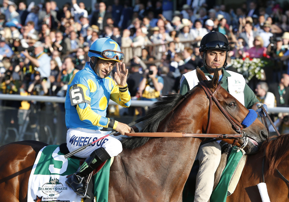 American Pharoah with Victor Espinoza up parades to the starting gate before the 147th running of the Belmont Stakes. The Associated Press